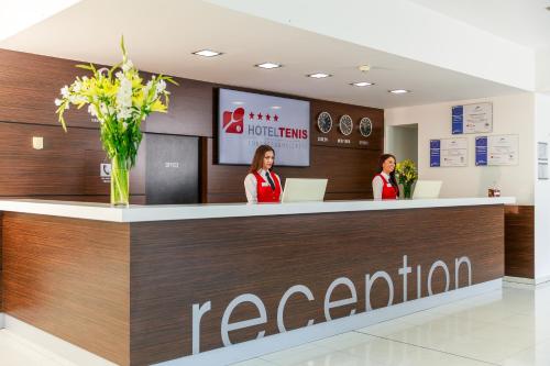 two women standing at the reception counter of a kazarin store at Hotel TENIS in Zvolen