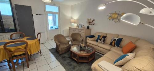 a living room with a couch and a table at T3 spacieux lumineux jardin et proche du tram in Pont-de-la-Maye