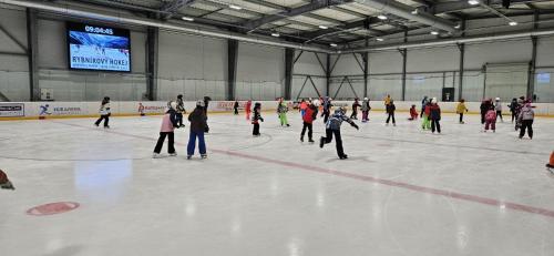 a group of people skating on an ice rink at Hotel TENIS in Zvolen