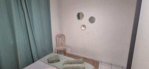 a small room with a chair and a table and a chair at T3 spacieux lumineux jardin et proche du tram in Pont-de-la-Maye