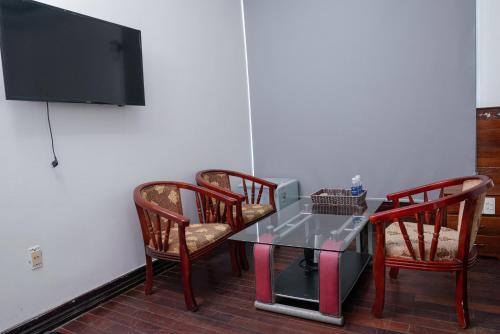 a room with a table and two chairs and a tv at Khách Sạn Như Mai in Quang Tri