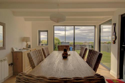 a dining room with a wooden table and chairs at Wilsons, Golspie in Golspie