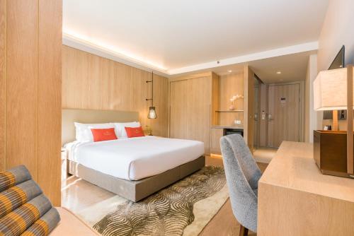 a hotel room with a bed and a desk at Divalux Resort & Spa Bangkok, Suvarnabhumi Airport-Free Shuttle in Lat Krabang