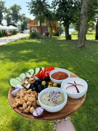 a plate of food with different foods on a table at Potcoava Dunarii in Suhaia