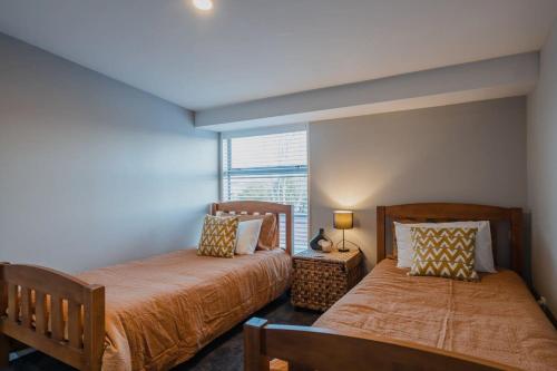 a bedroom with two beds and a window at The Dream Townhouse in Christchurch
