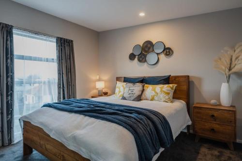 a bedroom with a large bed and a window at The Dream Townhouse in Christchurch