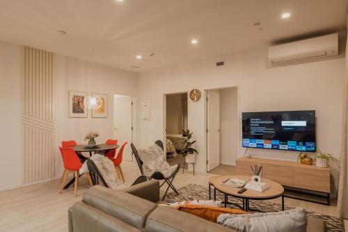 a living room with a couch and a tv at Tuam on Top Sleeps 5 in Christchurch