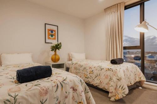 a bedroom with two beds and a window at Tuam on Top Sleeps 5 in Christchurch