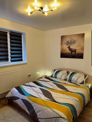 una camera con letto e una foto di un cervo di Chic Urban Retreat a Drîmbar