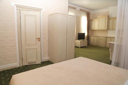a room with a bed and a bathroom with a television at BEK PLUS HOTEL in Takchilik