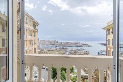 a balcony with a view of the water and buildings at Principe FS & San Teodoro District Elegant Apartment in Genova