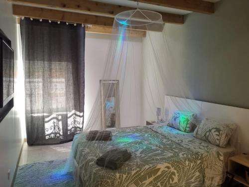 a bedroom with a bed with blue lights on it at Maison entière 120 m2 Aix en Provence et grand jardin in Aix-en-Provence