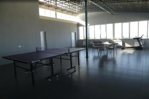 a large room with tables and chairs and windows at BEK PLUS HOTEL in Takchilik