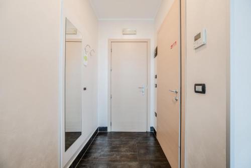 a hallway with white walls and a door at Hotel Milano Navigli in Milan