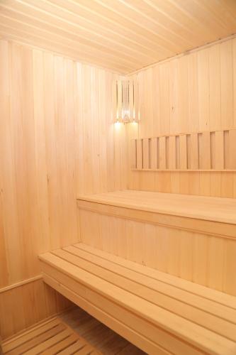 a sauna with wood paneling and a light fixture at BEK PLUS HOTEL in Takchilik