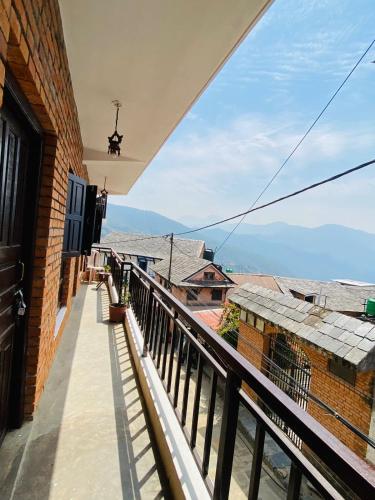 a balcony with a view of a building at Diya's Guest House - Family Environment in Bandīpur