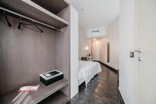 a small room with a bed and a room with a door at Hotel Milano Navigli in Milan