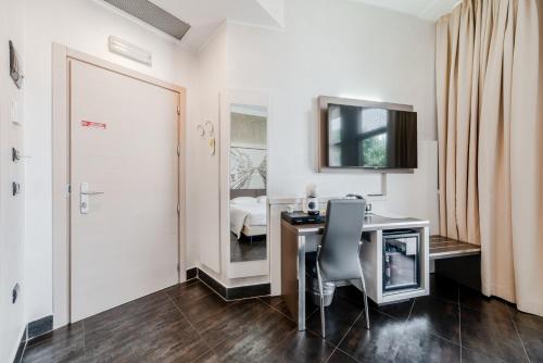 a room with a desk with a chair and a door at Hotel Milano Navigli in Milan