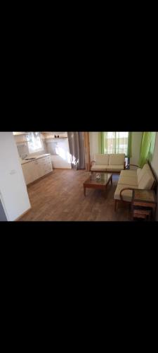a living room with two couches and a coffee table at חוות קשואלה Kashuela Farm in Bat Ayin