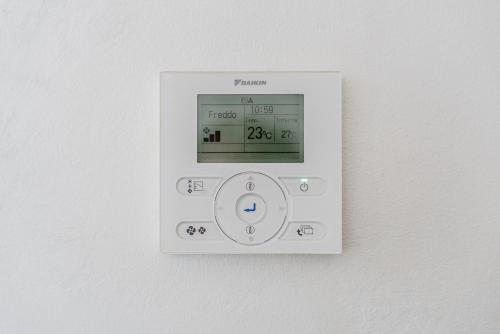 an electronic lightswitch on a white wall at Hotel Milano Navigli in Milan