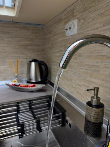a kitchen sink with a water faucet at NOA Luxury Apartment in Bitola