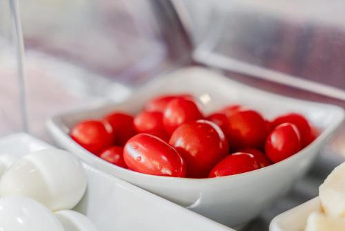 a white bowl filled with tomatoes on a counter at Hotel Milano Navigli in Milan
