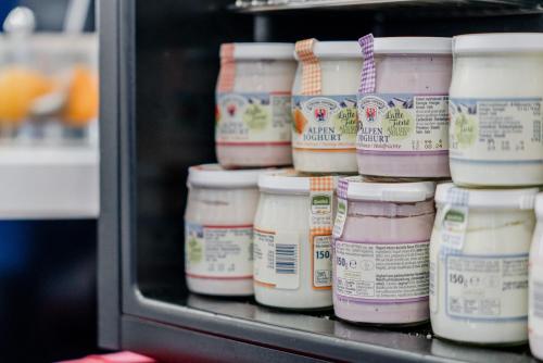 a refrigerator filled with lots of different types of mayonnaizers at Hotel Milano Navigli in Milan
