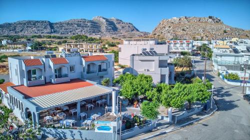 an aerial view of a city with mountains in the background at Tommy's Rooms in Haraki