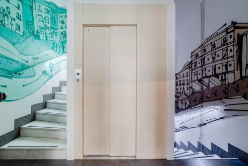 a hallway with stairs and a painting on the wall at Hotel Milano Navigli in Milan