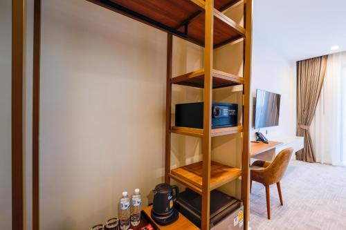 a room with a bunk bed with a desk and a computer at Betworld Casino & Hotel in Krong Poi Pet