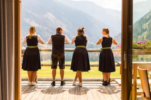 a group of people looking out of a window at Almfamilyhotel Scherer in Obertilliach