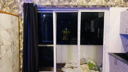 a sliding glass door with a tshirt in a kitchen at Auro studio home in Pūrnānkuppam