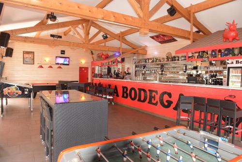 a restaurant with a pool table and a bar at Camping Officiel Siblu Les Embruns in Lège-Cap-Ferret