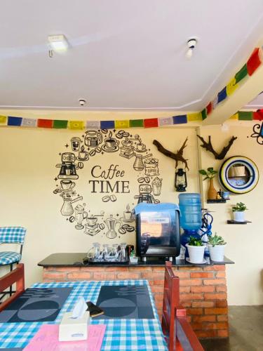 a room with a coffee time sign on the wall at Diya's Guest House - Family Environment in Bandīpur