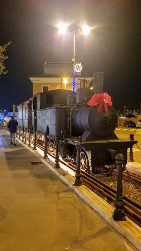 a train engine sitting on the tracks at night at The Stopover Suite House 2 in Fiumicino