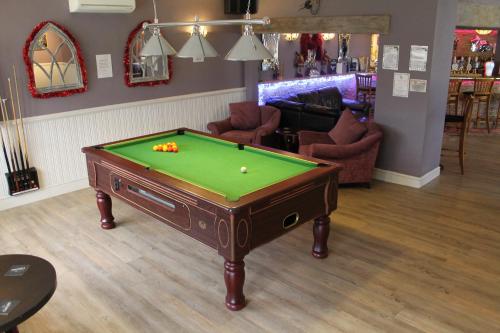 a pool table in the middle of a room at The Swan Motel, Gillingham in Beccles