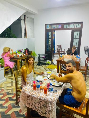 a group of people sitting at a table eating at Mario Family Villa and Restaurant in Negombo