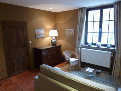 a living room with a couch and a window at Maison Chantraine in Ramillies