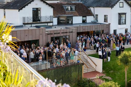 a large group of people standing outside of a building at Royal Ocean Racing Club in West Cowes