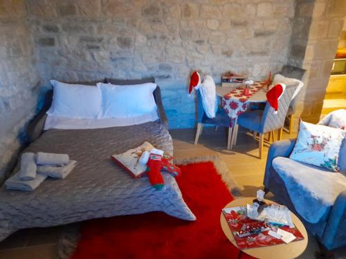 a bedroom with a bed and a table and a chair at Elen's Suites Pramanta in Pramanta
