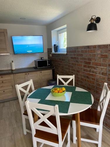a kitchen with a table with a bowl of fruit on it at Liptov Odessa in Liptovský Mikuláš