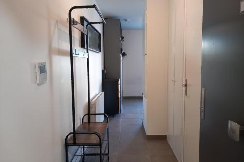 un couloir avec deux chaises et une télévision sur un mur dans l'établissement 69A - Cosy studio ideally located Lyon Gerland, à Lyon