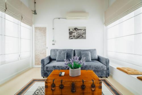 a living room with a couch and a table at Xinlor House - Phuket Old Town in Phuket Town
