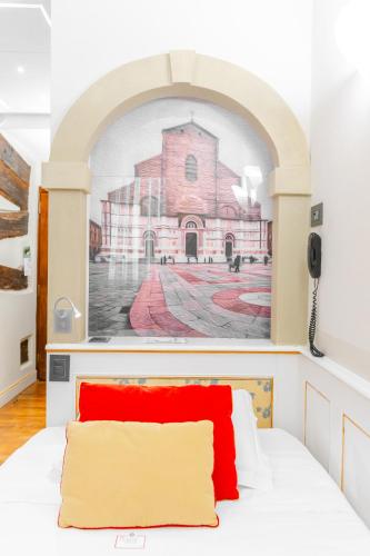 a bedroom with a painting of a church at Art Hotel Commercianti in Bologna