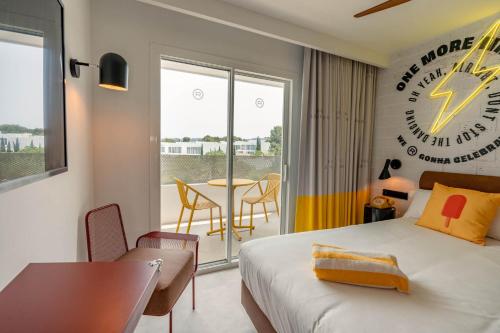 a hotel room with a bed and a table and a clock at Ryans Lolas - Adults Only in San Antonio Bay