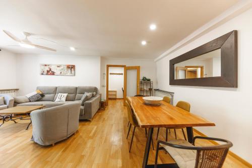 a living room with a table and a couch at SantPauLux in Sant Pau de Seguries