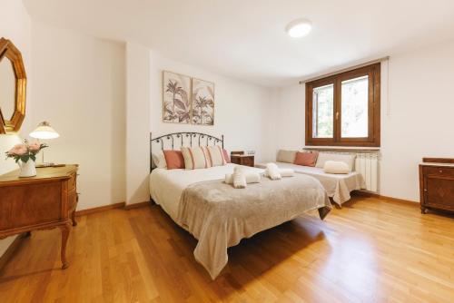a bedroom with a large bed and a wooden floor at SantPauLux in Sant Pau de Seguries