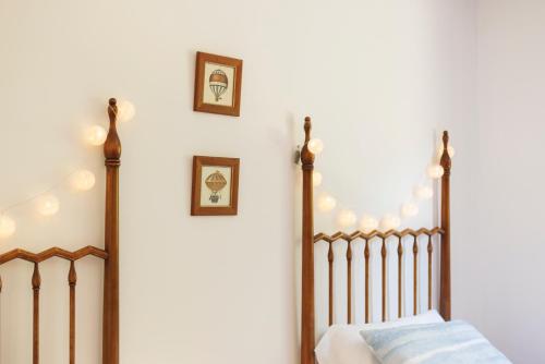 a bedroom with a crib and two pictures on the wall at SantPauLux in Sant Pau de Seguries