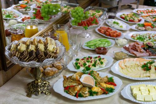 a table full of plates of food on a table at Hotel Hesperus in Międzyrzec Podlaski