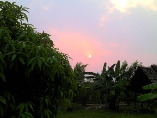 a sunset seen from the garden of a house at Ing Doi Guest House in Pai
